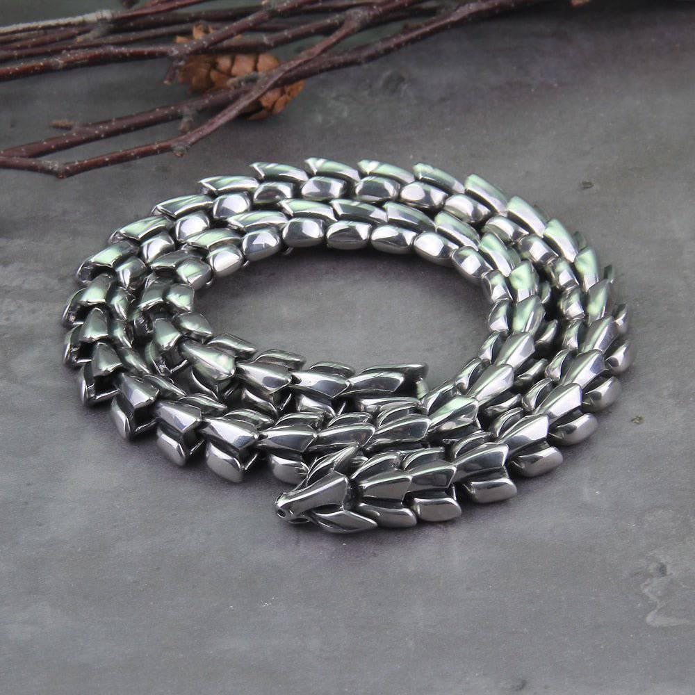 A coiled stainless steel necklace with scales, inspired by the mythological Jormungandr.