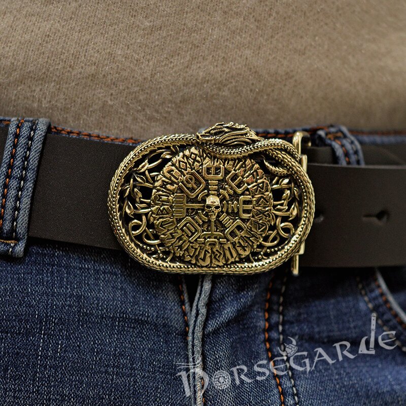 Close-up of a belt with a decorative Viking buckle on a denim background, featuring the brand 'Norsegarde'.
